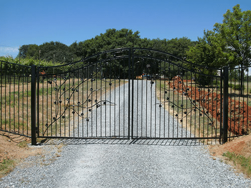 Driveway gate built along a metal fence