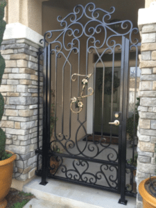 Metal Gate with swirls and monogram in the center