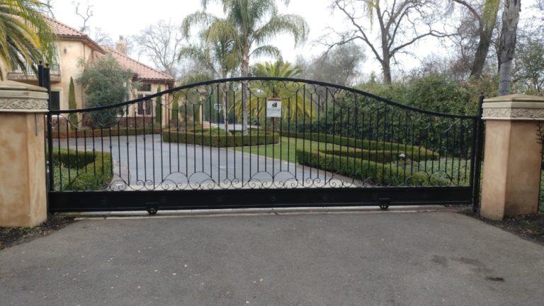 Driveway gate with swirl design at the top and bottom