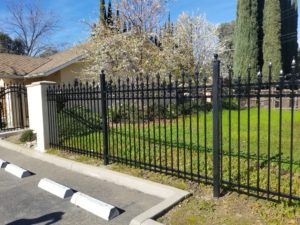 An iron fence in the front yard