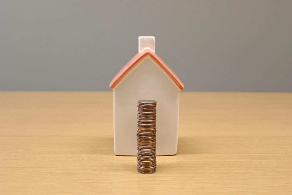 Coins in front of a house showing ROI increasing