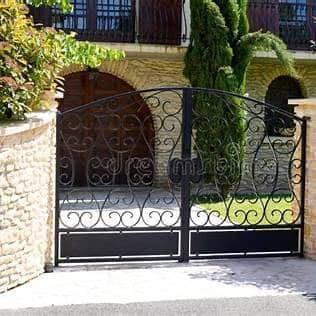 Metal Gates in front of a beautiful house